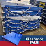  Stack of blue industrial forklift container ramps secured with chains, placed on a warehouse floor, labelled "Clearance Sale!" in the foreground
