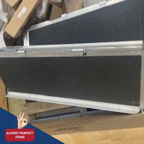 Close-up of a black aluminium ramp with anti-slip surface stacked on cardboard boxes, marked with a red 'Almost Perfect Items' label.