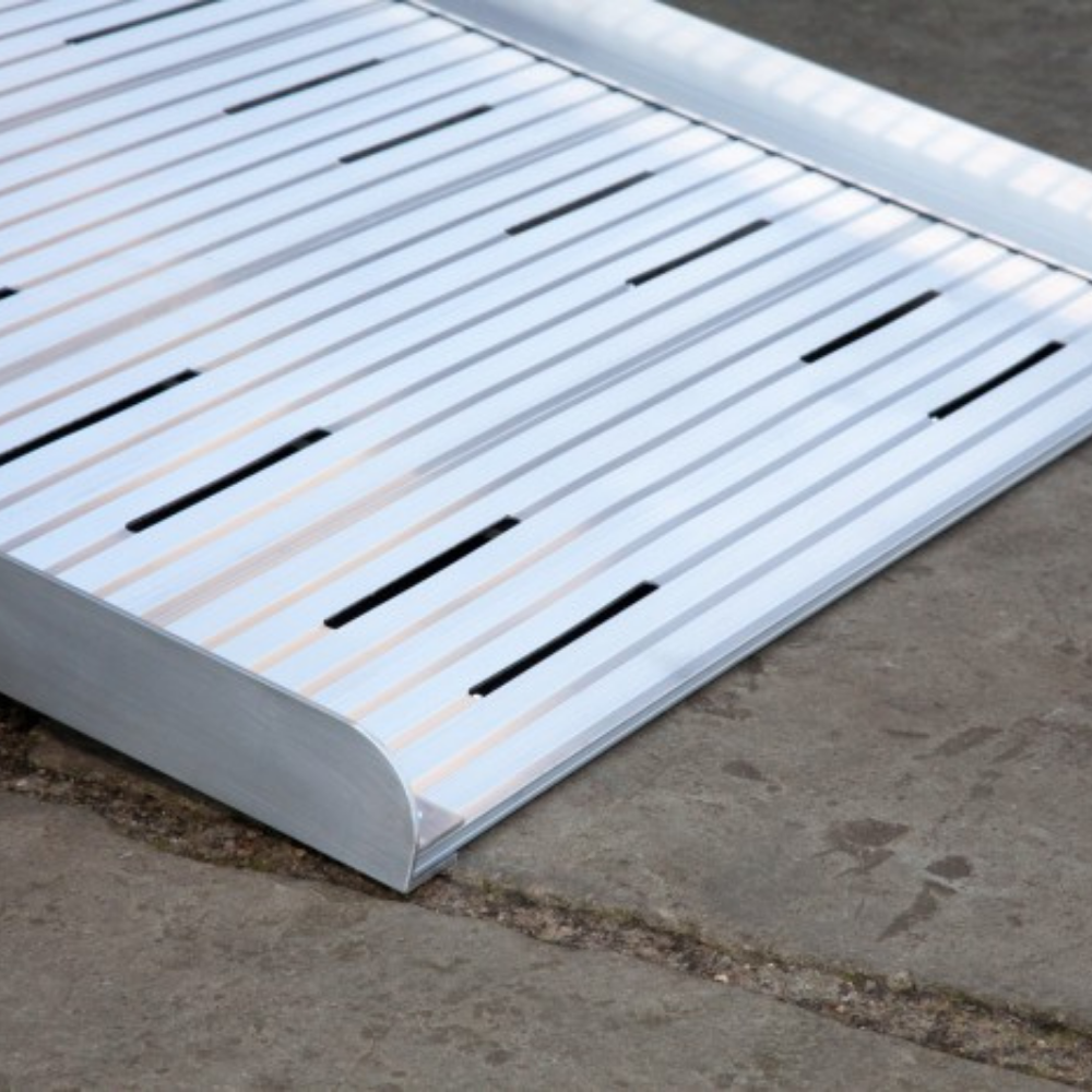 Heeve® Aluminium Non-Folding Wheelchair Ramp with Open Grid Deck on a concrete surface