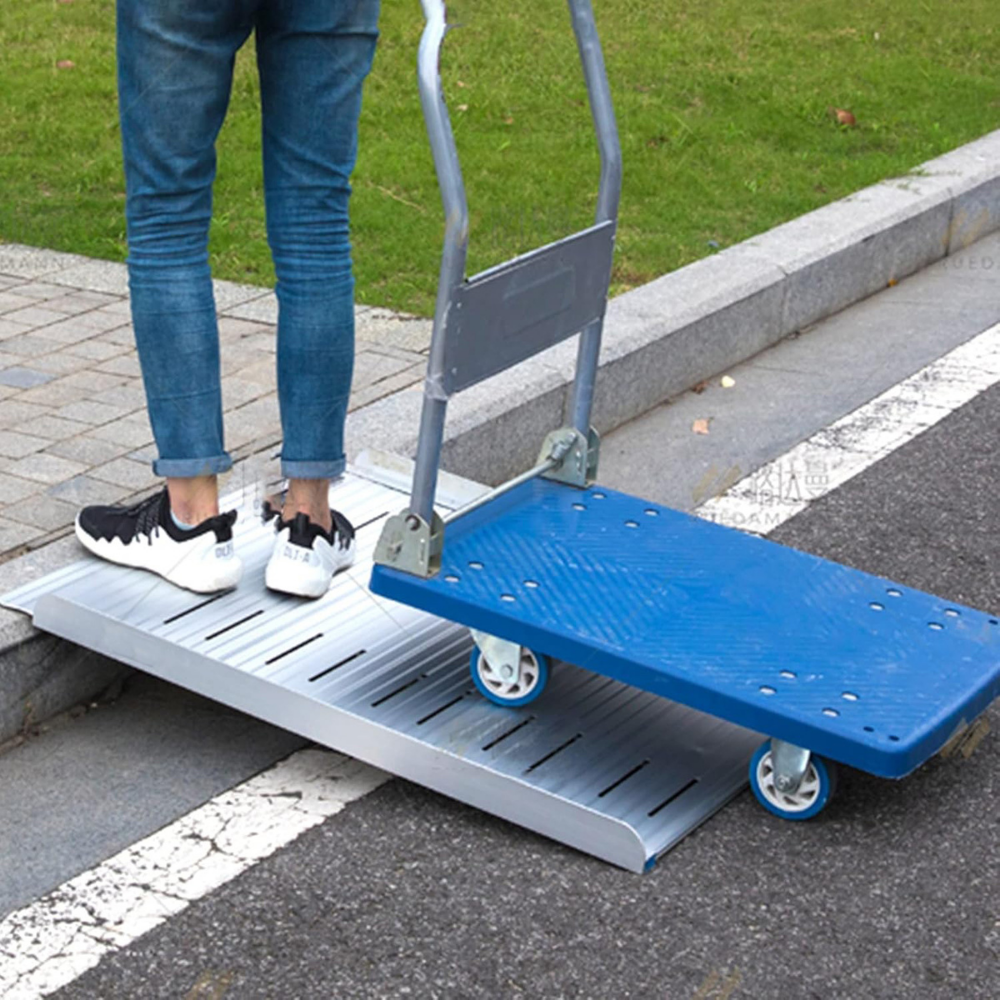 Person using a blue and silver hand truck with a ramp to navigate stairs.