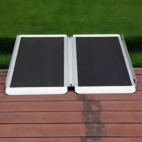 Heeve aluminium single-fold ramp lying flat on wooden planks, with visible raised edges for added user safety and support