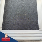 A close-up of a dark gray surface of aluminium ramp, with a small hand gesture and a red badge reading 'ALMOST PERFECT ITEMS' in the lower left corner.