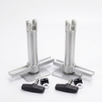 Two silver metal mounting posts with flat base plates, shown with four black wing nuts and small black hardware pieces on a clean white background.