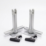 Two silver metal mounting posts with flat base plates, shown with four black wing nuts and small black hardware pieces on a clean white background.