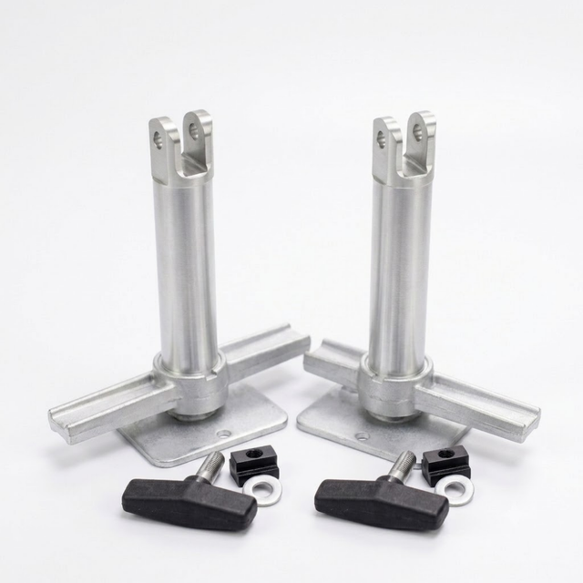 Two silver metal mounting posts with flat base plates, shown with four black wing nuts and small black hardware pieces on a clean white background.