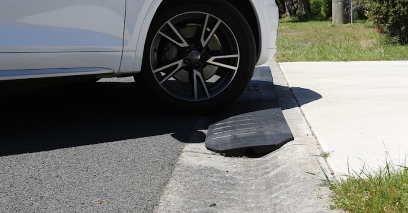Car approaching a rubber ramp on a road