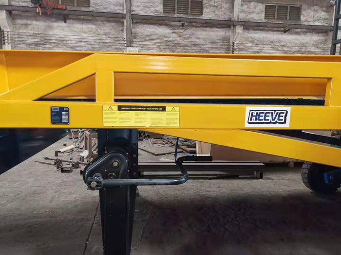 Heavy steel yellow frame and leg of a Heeve yard ramp