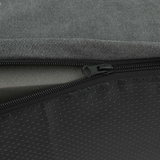 Close-up of a zipper on a gray and black textured foam cover