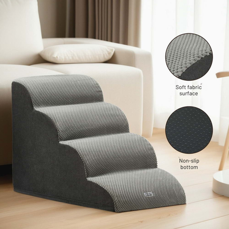 Gray pet stairs with soft fabric surface and non-slip bottom in a living room setting.
