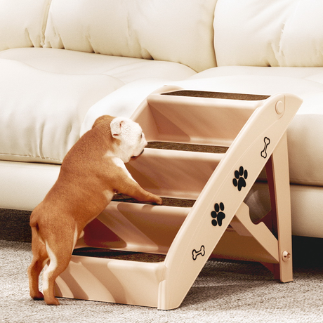 Dog using a set of beige pet stairs to climb onto a couch.