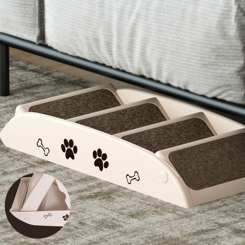 Pet ramp with paw and bone designs on a carpeted floor.