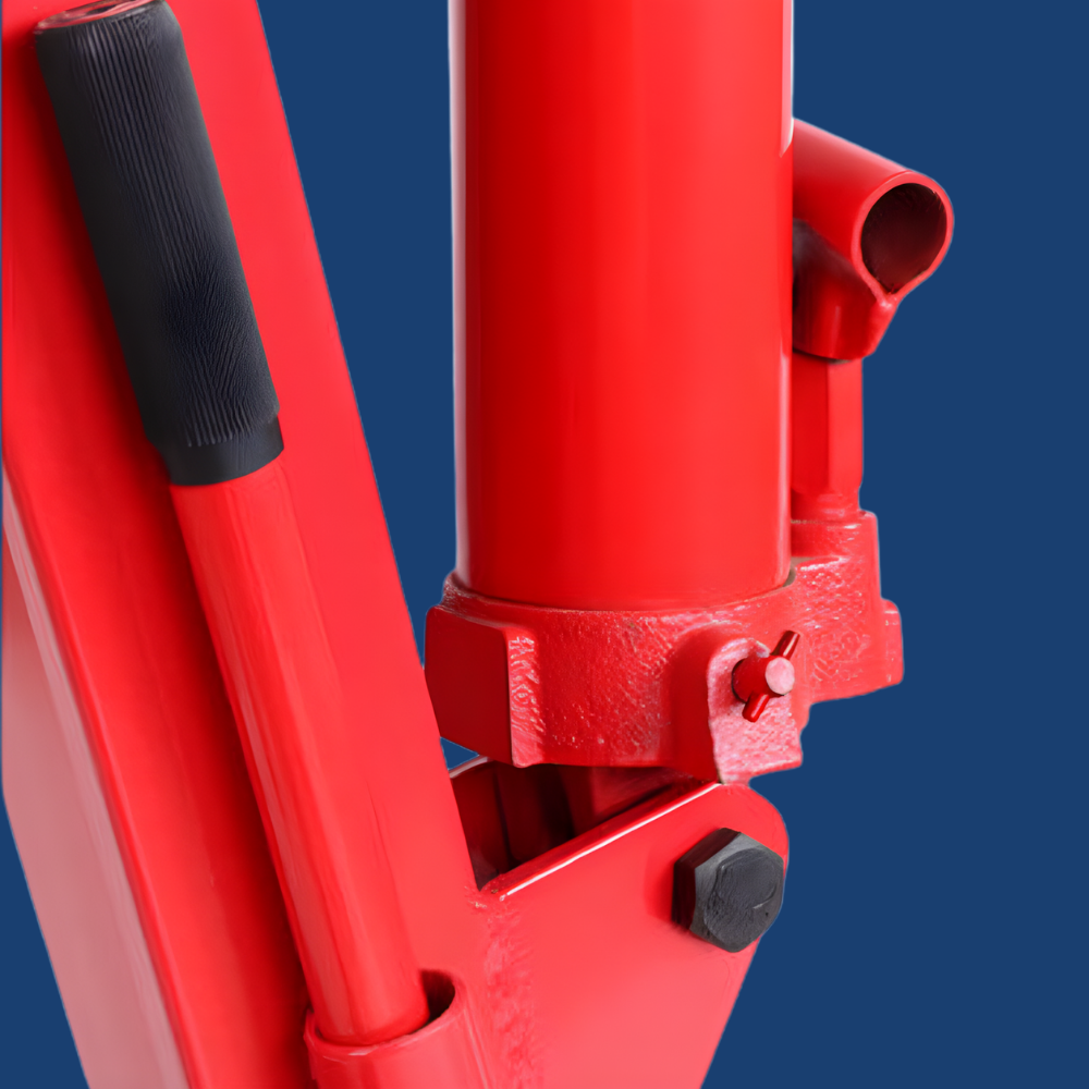 Red hydraulic jack with black handles on a blue background