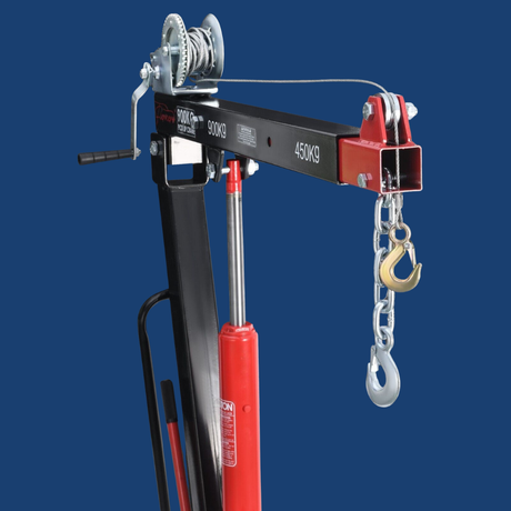 Red and black crane with chain hoist on a blue background