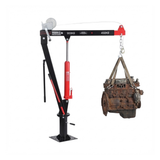 Mechanical lifting device with a crane hook lifting an engine on a white background
