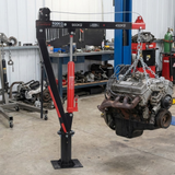 Engine hoist lifting an engine in a workshop setting