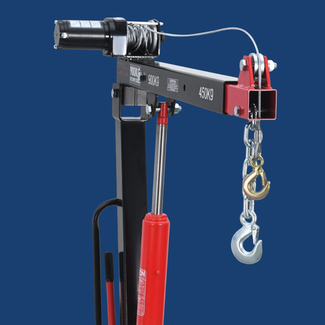 Pneumatic hoist with red cylinder and chain hook on a blue background