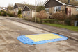 Oxford Plastics LowPro 15/05 road plate with end ramps installed on a residential street