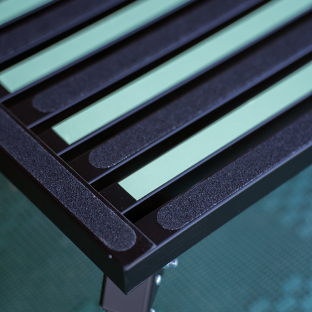 Close-up of a black and green striped object on a blurred background