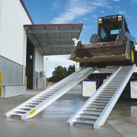 backhoe on the ramp on concrete parking