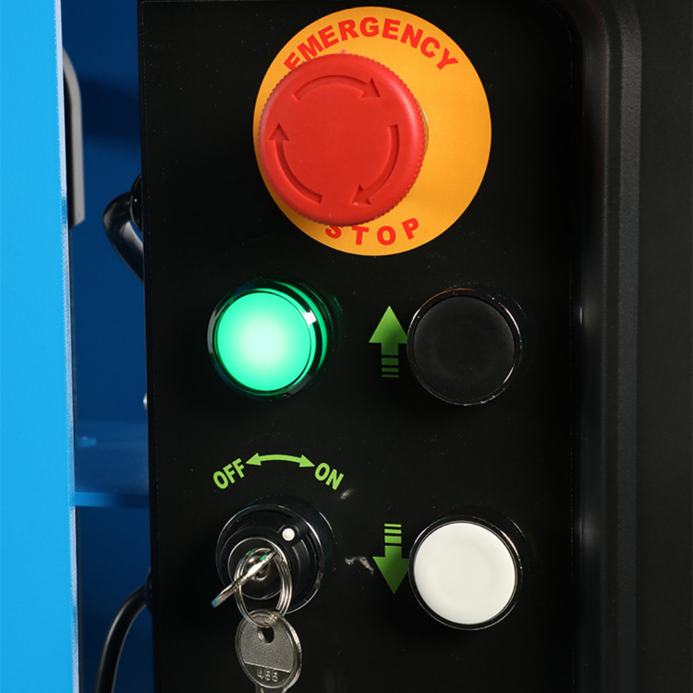 Control panel with emergency stop button, green indicator light, and key switch.