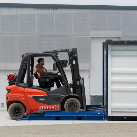 man driving the forklift on the Troden 10-Tonne Extra Long Steel Container Ramp