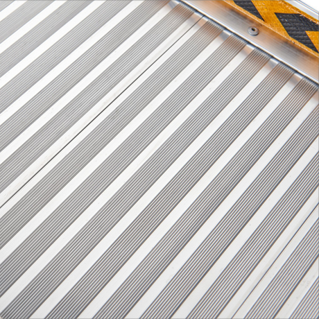 Macro view of the aluminium anti-slip surface, showing parallel grooves for traction.

