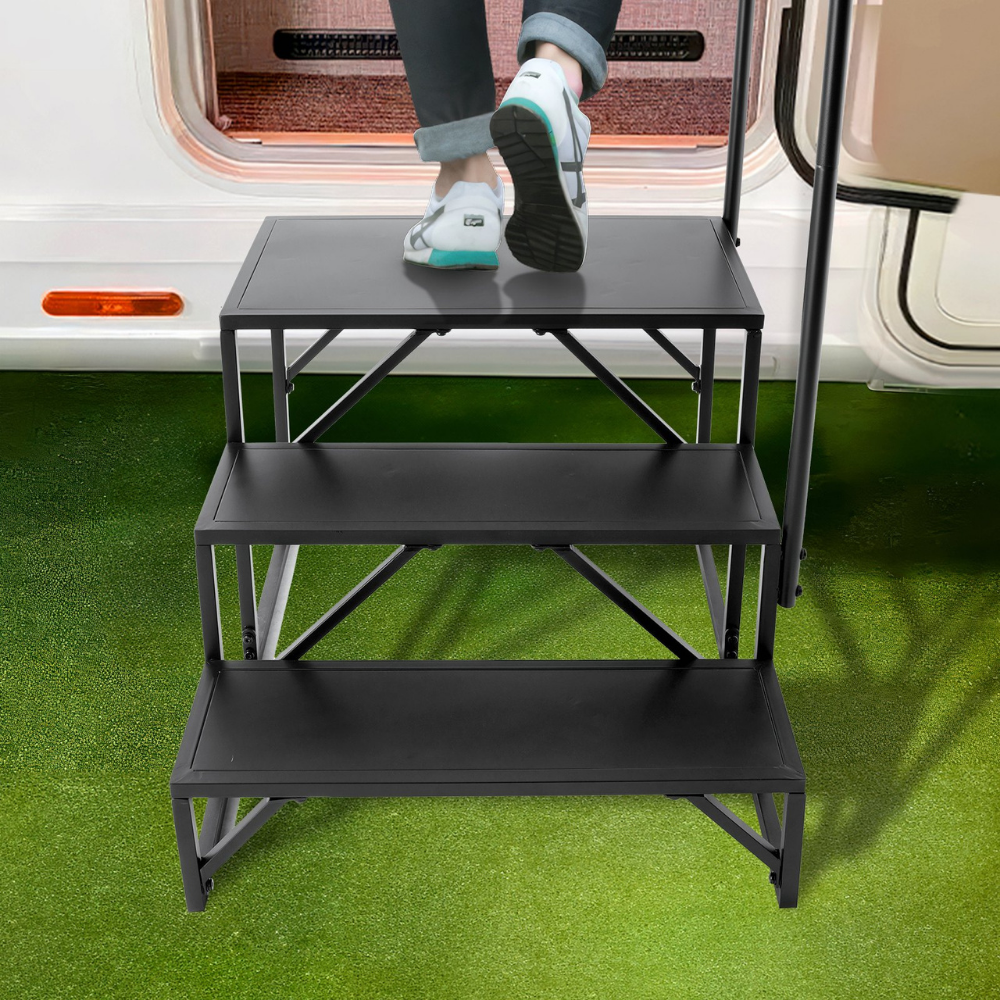 Person using a black step stool to climb into a vehicle on grass