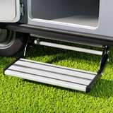 Step ladder attached to a vehicle on grass