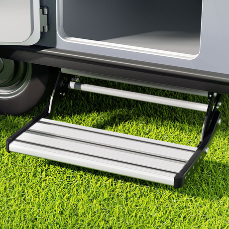 Step ladder attached to a vehicle on grass