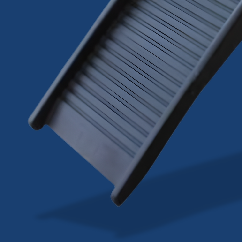 Gray rectangular object with textured surface on a blue background