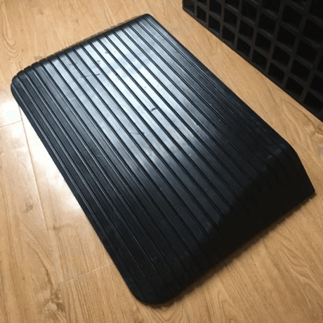 black rubber ramp on wooden planks